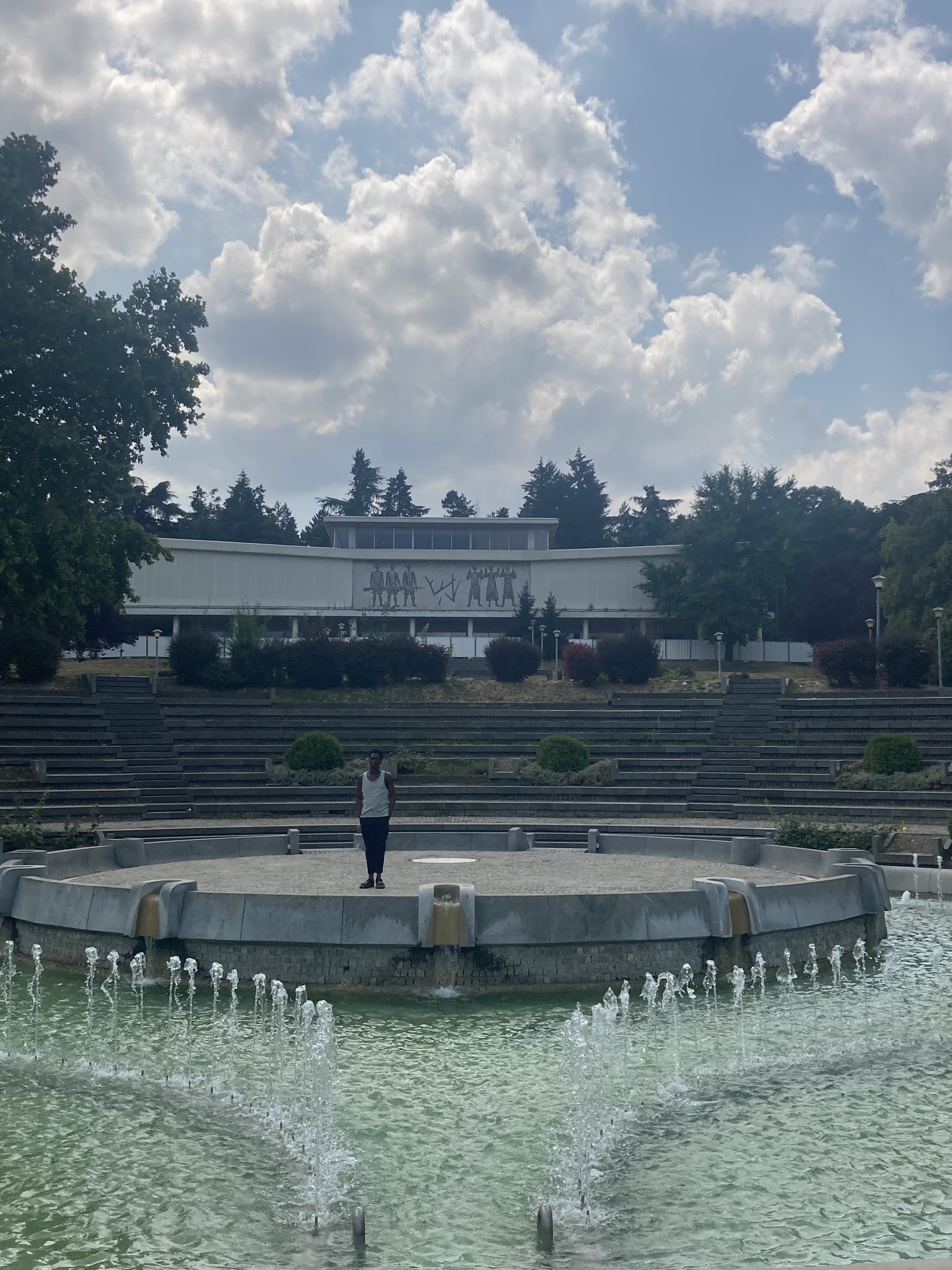 Akinsola standing in front of Museum of Yugoslavia